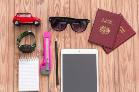 KUALA LUMPUR, MALAYSIA - JUNE 22, 2016 : toy car, bag, ipad and note book. Travel Concept.のeditorial素材