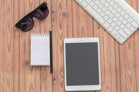 KUALA LUMPUR, MALAYSIA - JUNE 22, 2016 : keyboard, sanglass, ipad and note book. Travel Concept.のeditorial素材