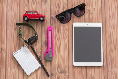 KUALA LUMPUR, MALAYSIA - JUNE 22, 2016 : toy car, bag, ipad and note book. Travel Concept.のeditorial素材