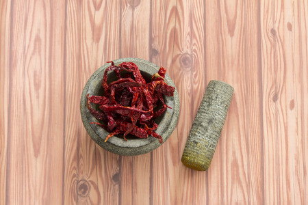 Dried peppers in mortarの写真素材