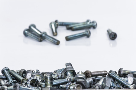 Chrome nuts and bolts closeup on plain backgroundの写真素材