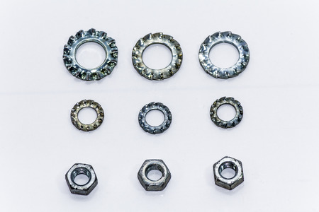 Chrome nuts and bolts closeup on plain background