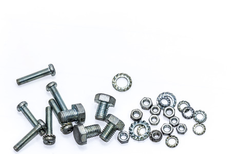 Chrome nuts and bolts closeup on plain background