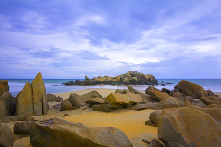 rocks on the beach during the day and the rocks in the sea like human sleepの写真素材