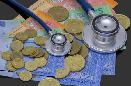 concept with stethoscope and gold coinsの写真素材