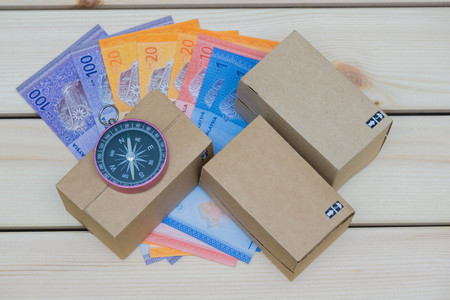 Box, compass and money on the tableの写真素材