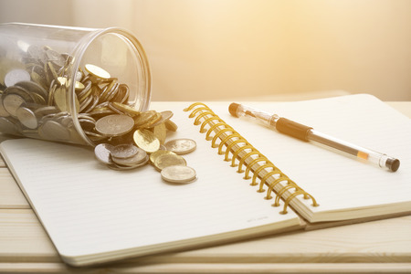 Concept close up of book, coin and pen.の写真素材