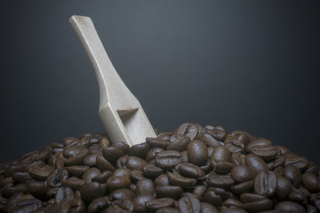 close up coffee beans and wooden spoon.の写真素材