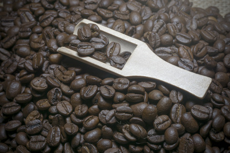 close up coffee beans and wooden spoon.の写真素材
