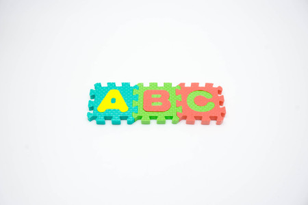 Colorful foam puzzle with word on a white background.の写真素材
