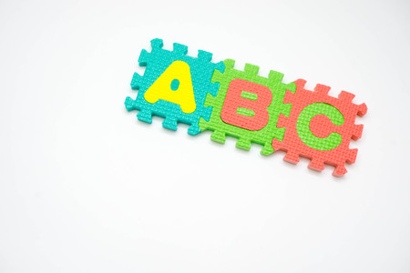 Colorful foam puzzle with word on a white background.の写真素材