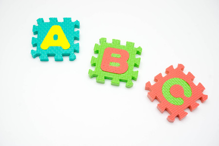 Colorful foam puzzle with word on a white background.の写真素材