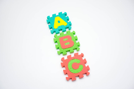 Colorful foam puzzle with word on a white background.の写真素材