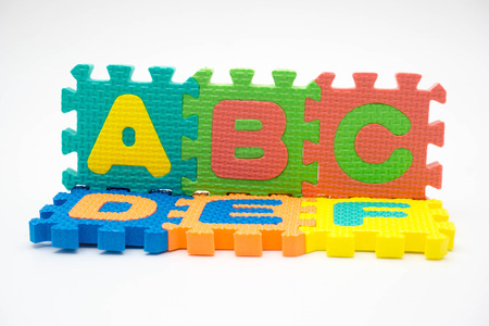 Colorful foam puzzle with word on a white background.の写真素材