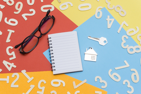 notebooks and glasses in the center of colorful paper and scattered numbersの写真素材