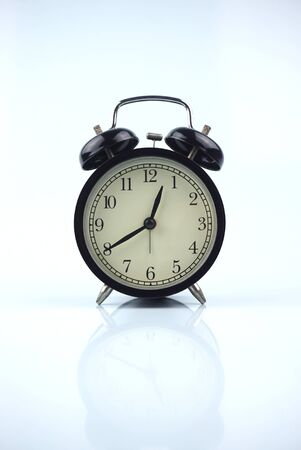 black bell clock with white backgroundの写真素材