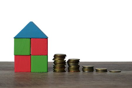 blocks of wood become houses and coinsの写真素材