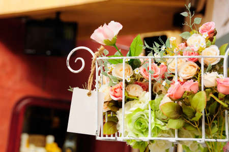 Artificial flower in white iron basketの写真素材