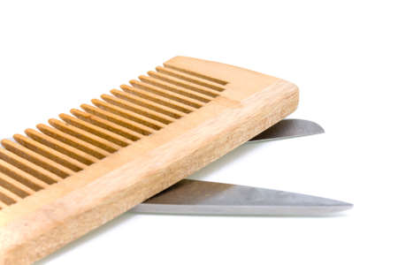 Some wooden hairbrush and scissors on a white backgroundの写真素材