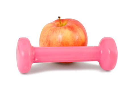 one dumbbell and red apple on a white backgroundの写真素材