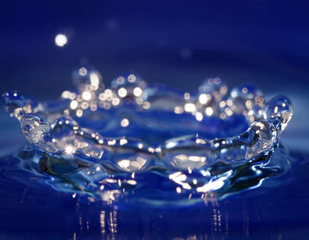 Splash of Wather on blue background. Water symbol.