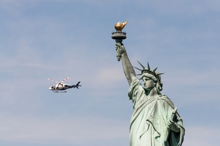 NEW YORK - JULY 2010 - NYDP helicopter guards the Statue of Liberty のeditorial素材