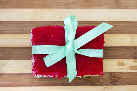 rolls with a ribbon on a cutting board isolated overwhite