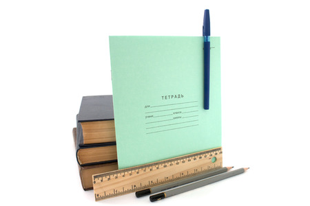 copybook and books isolated over whiteの写真素材