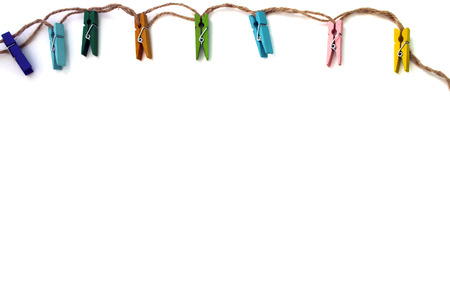 background of colored linen clothespins isolated on whiteの写真素材