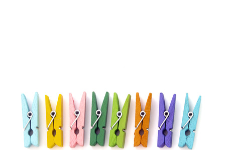 background of multi colored linen clothespins isolated on whiteの写真素材