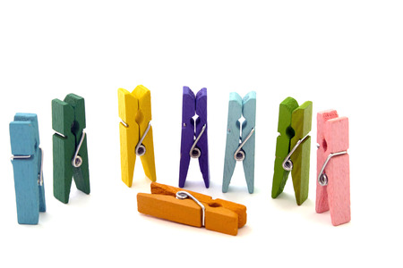 several colored linen pegs vertically isolated on white backgroundの写真素材