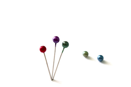 three pin stuck on a white backgroundの写真素材
