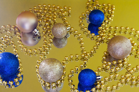 Christmas toys on a yellow background reflectionの写真素材