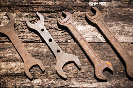 iron rusty tools wrench on an old wooden tableの写真素材
