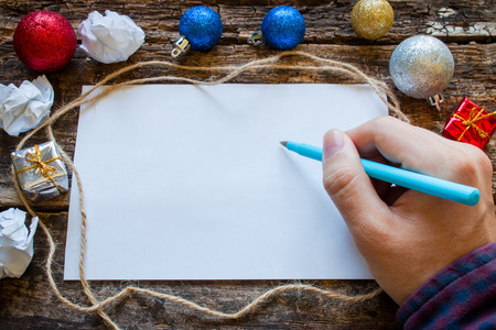 man writes a list of gifts for the new yearの写真素材