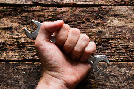 man holding a wrench in his handの写真素材