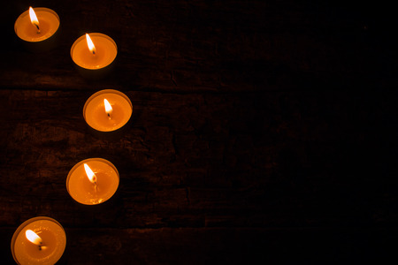 semicircle of candles on a black backgroundの写真素材