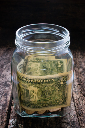 donations to help those in need of money in a glass jarの写真素材