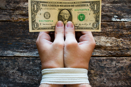 hands bound men and money in the hands - a symbol of slaveryの写真素材