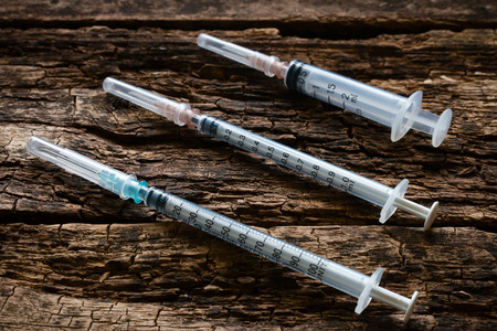 syringes on a wooden backgroundの写真素材