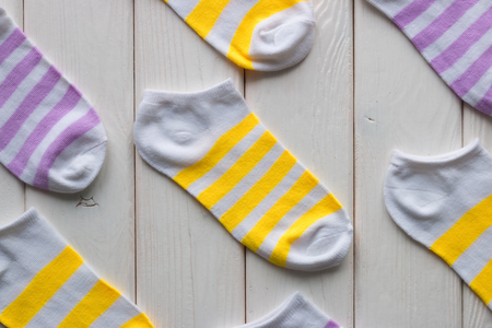 striped white socks on a white wooden backgroundの写真素材