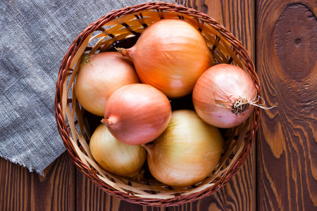 Basket with onions on a napkinの写真素材