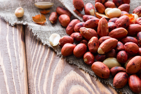 Peanuts on a napkin on a wooden background