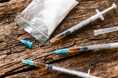 syringes and drugs on wooden background close-upの写真素材