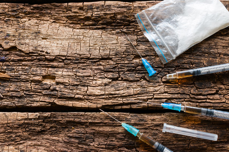 syringes and drugs on wooden background space for textの写真素材