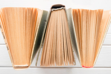Vintage books with yellowed pages on a white background closeup