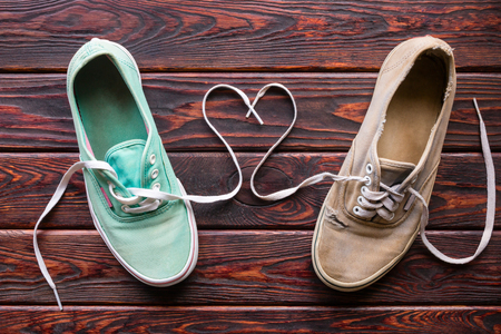 old shoes and heart from lace on the wooden backgroundの写真素材