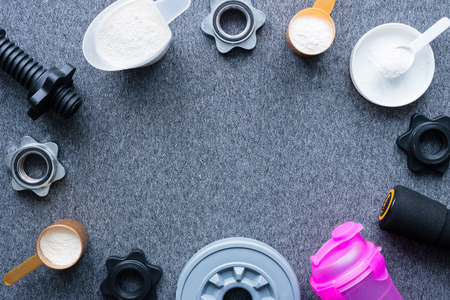 dumbbells and nutritional supplements for bodybuilding mockupの写真素材