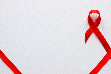 red ribbon symbol of World AIDS Day and space for textの写真素材