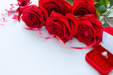 bouquet of red roses and wedding ring close-up with space for textの写真素材